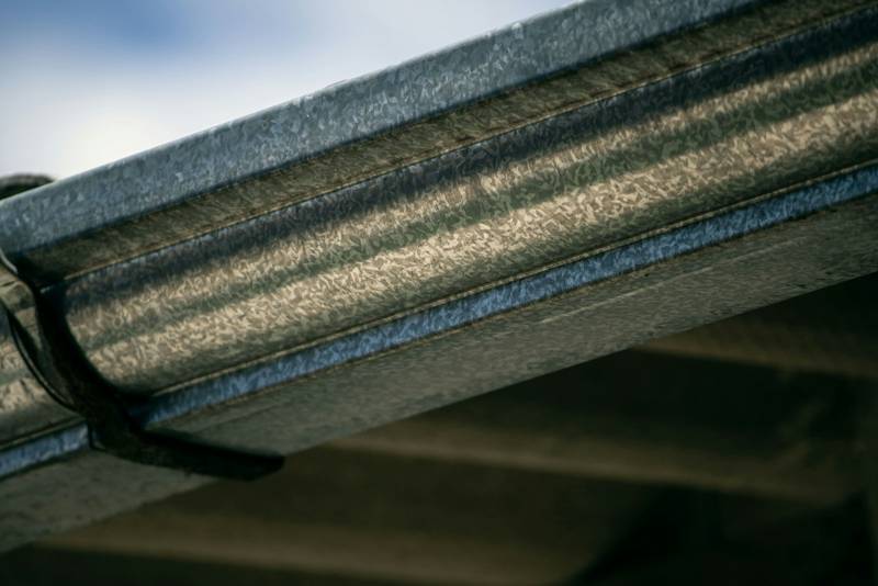 Close view of a metal gutter along a roof edge
